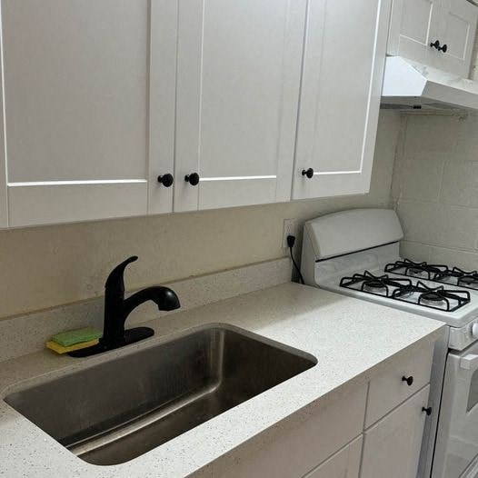 a kitchen with a sink and a stove