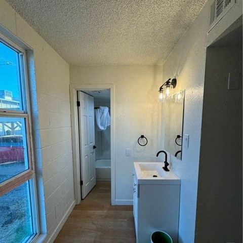 a small bathroom with a sink and a window