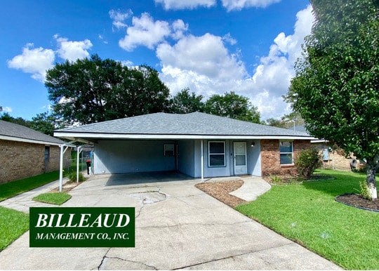 a blue house with a driveway and a blue sky