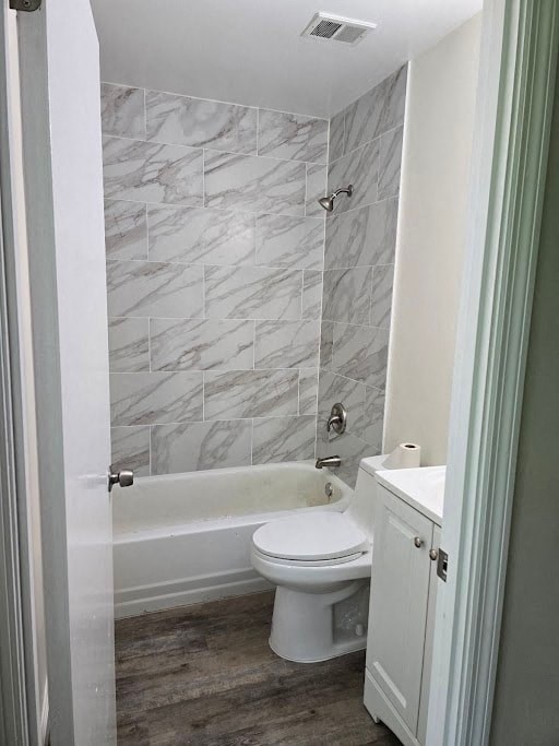 a bathroom with a toilet and a tub and a sink