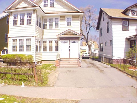 a white house with a driveway in front of it