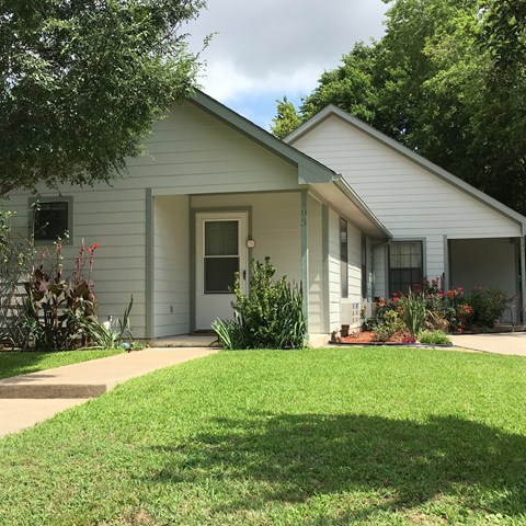 a white house with a lawn in front of it