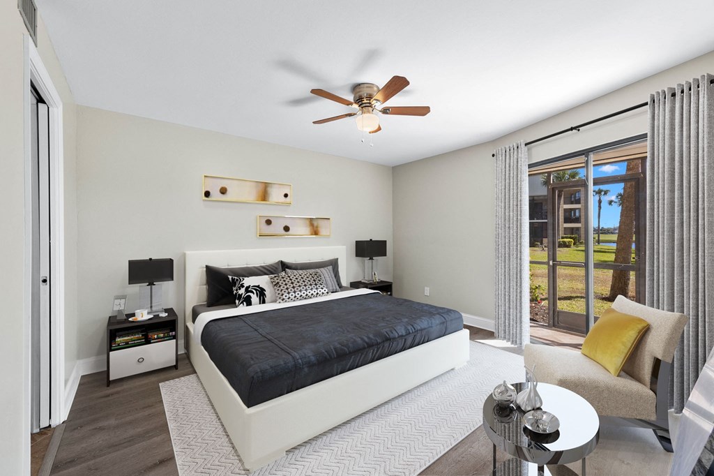 a bedroom with a bed and a ceiling fan