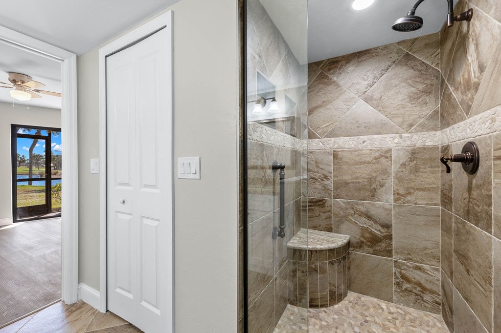a bathroom with a shower and a door