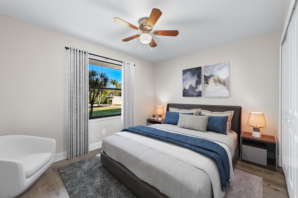 a bedroom with a bed and a ceiling fan