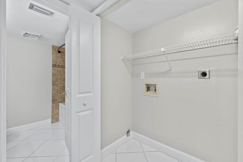 a bathroom with a closet and a door to a shower