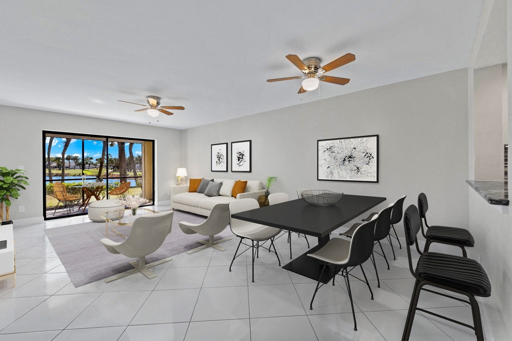 a living room and dining room with a table and chairs