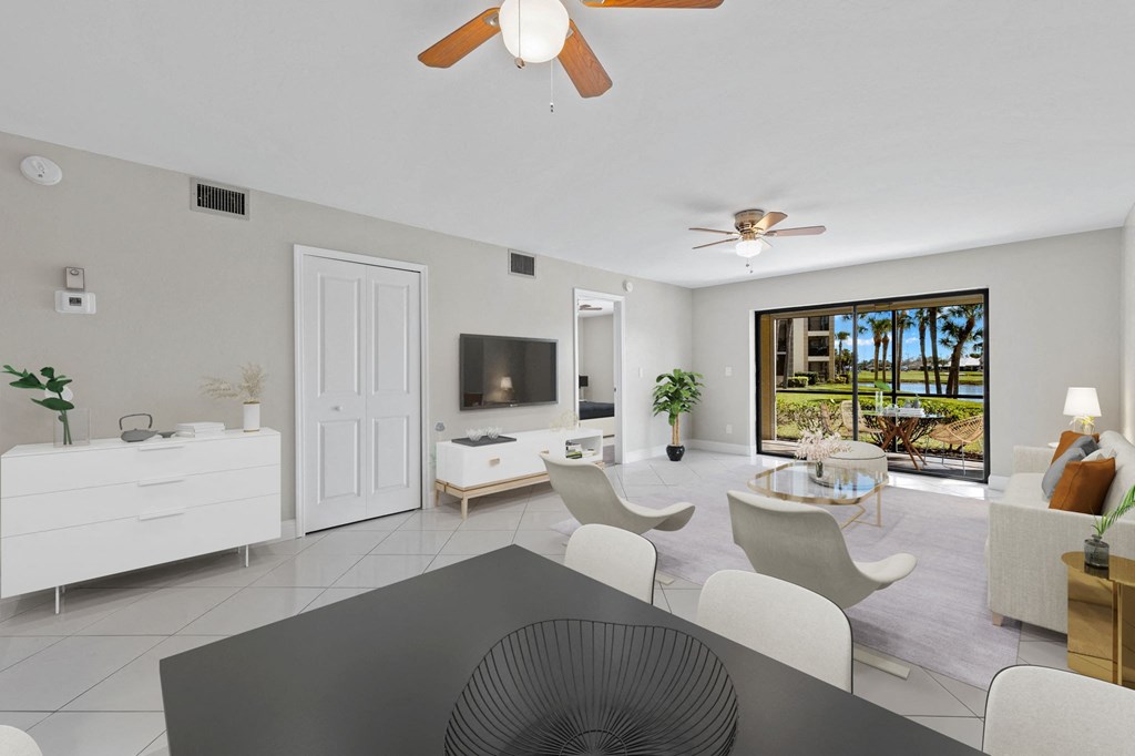 a living room with a table and chairs and a television