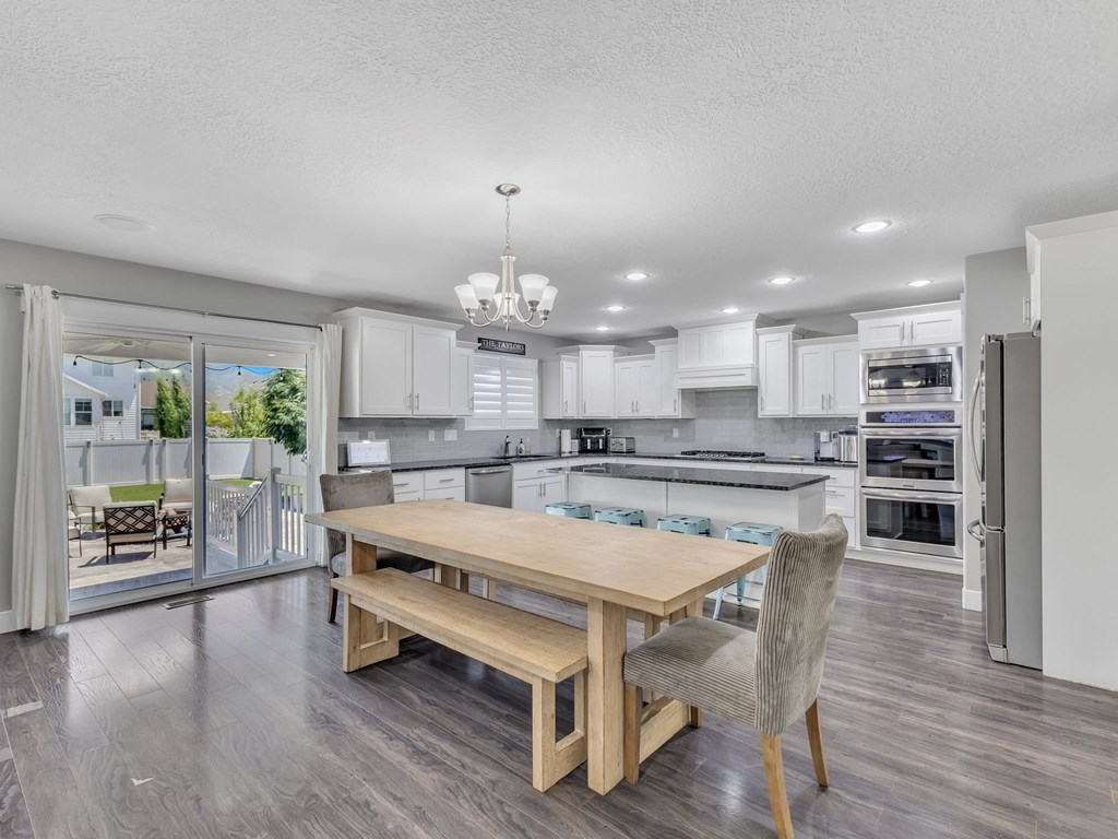 a kitchen and dining room with a table and chairs
