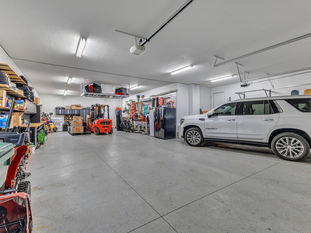 a garage with a white van parked in it and a lot of tools