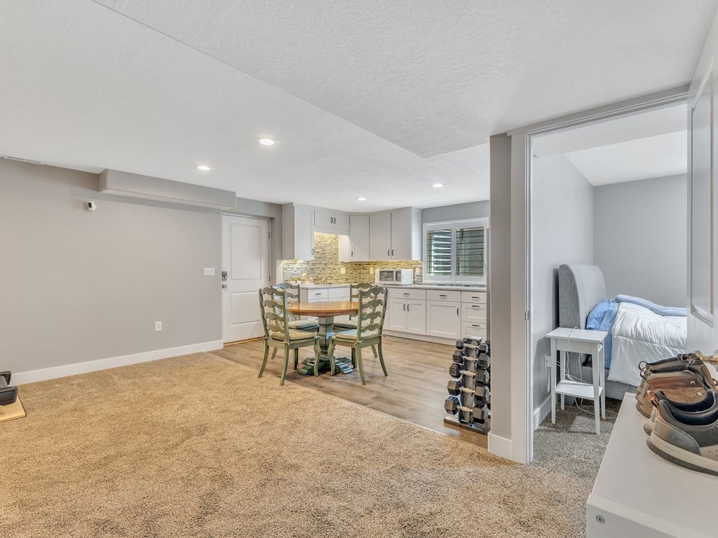 a living room and dining room with a kitchen and a bed