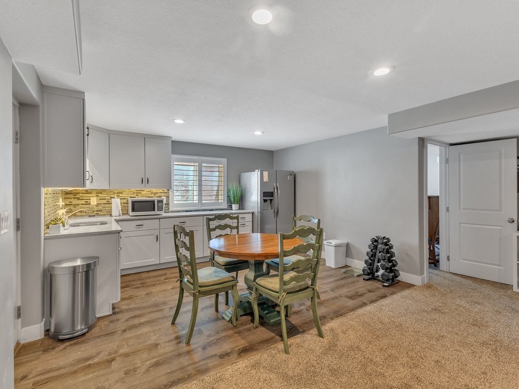 a kitchen and dining room with a table and chairs