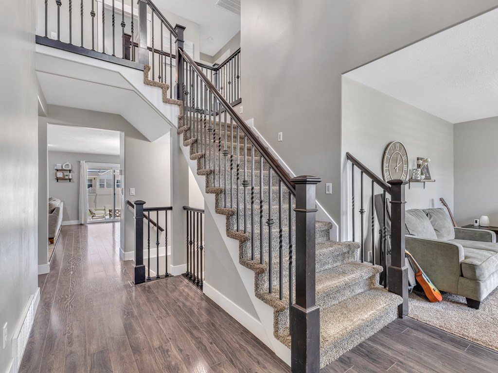 a staircase in a house with a living room and a couch