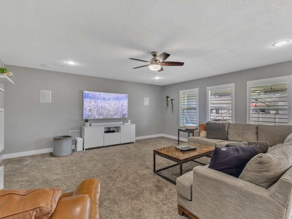 a living room with a couch and a ceiling fan