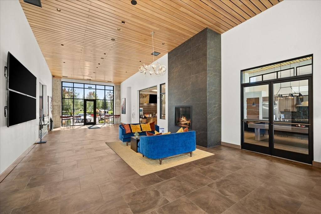 a large living room with a blue couch and a fireplace