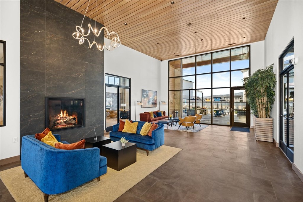 a living room with blue couches and a fireplace