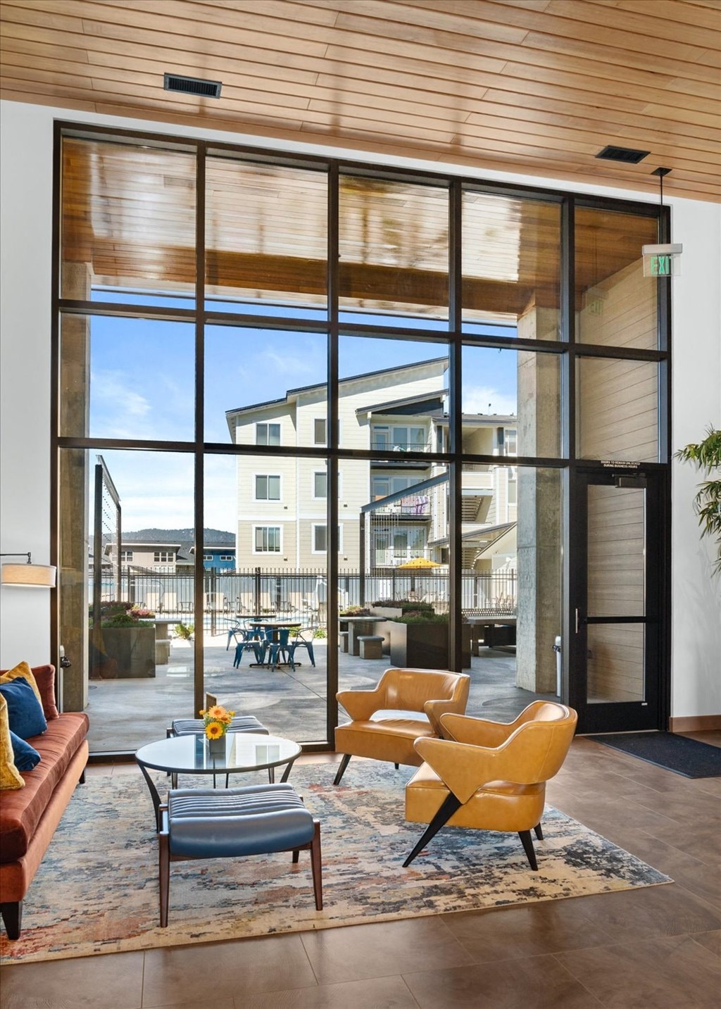 a living room with a couch and a coffee table in front of large glass doors