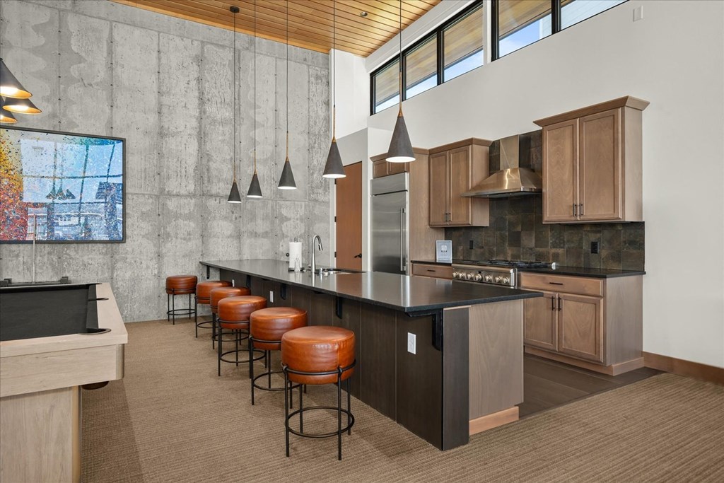 a large kitchen with a large island and bar stools
