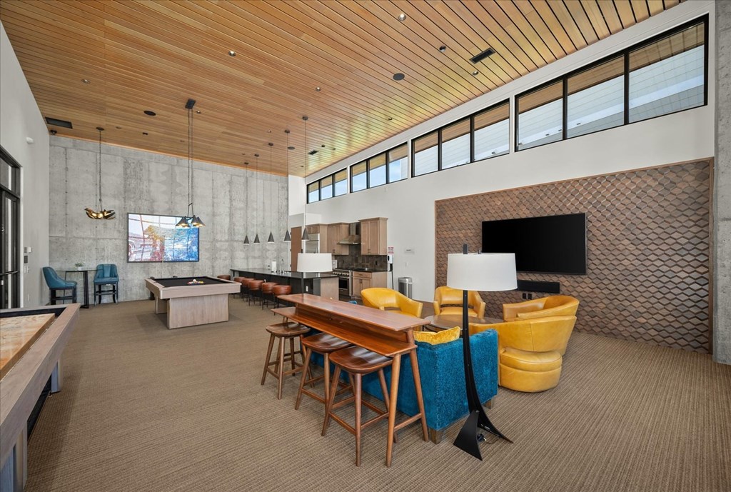 a large living room with a table and chairs