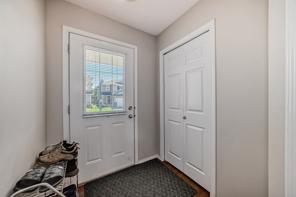 an empty bedroom with a closet and a window