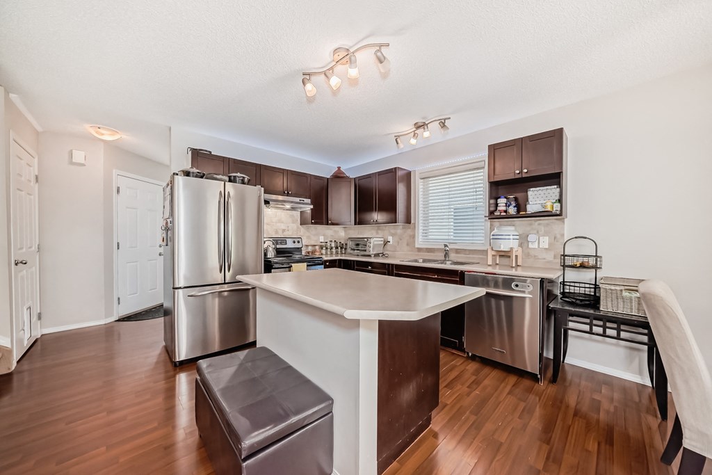 a kitchen with a large island and stainless steel appliances