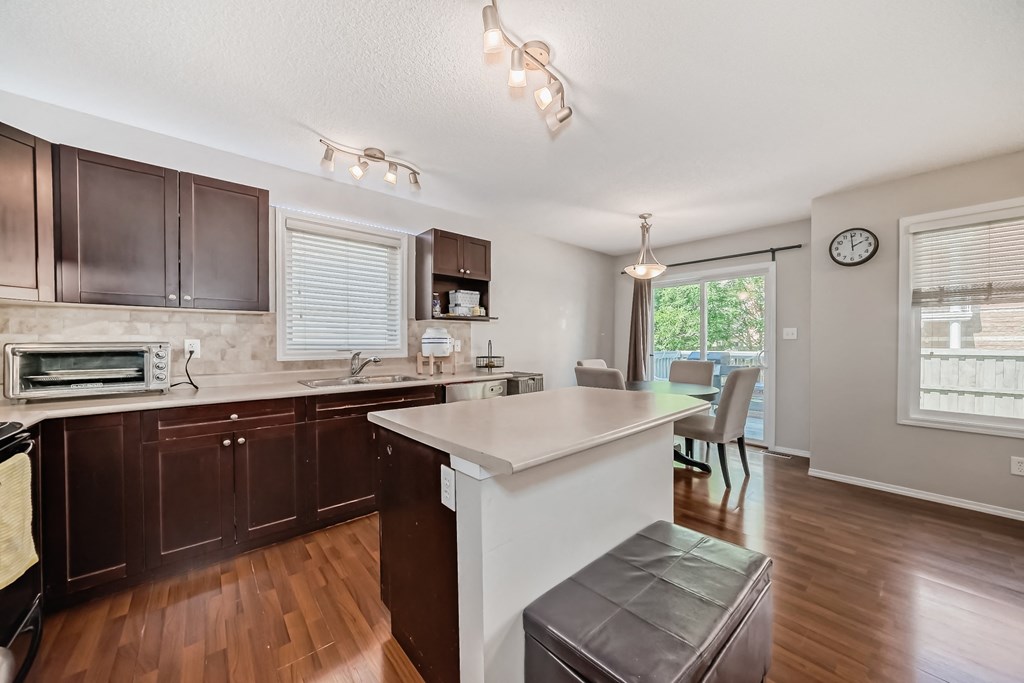 a kitchen with an island and a dining room with a table