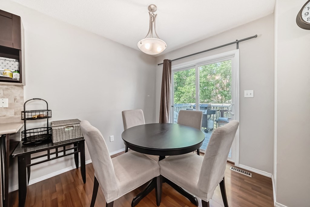 a dining room with a table and chairs and a large window