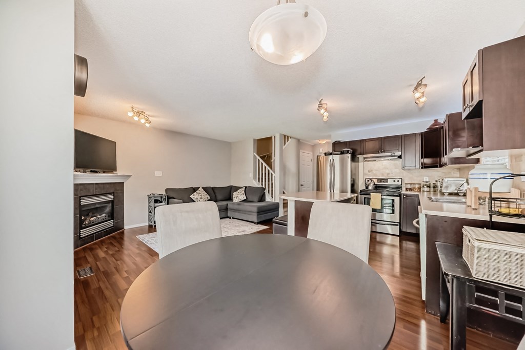 a living room with a dining room table and a kitchen