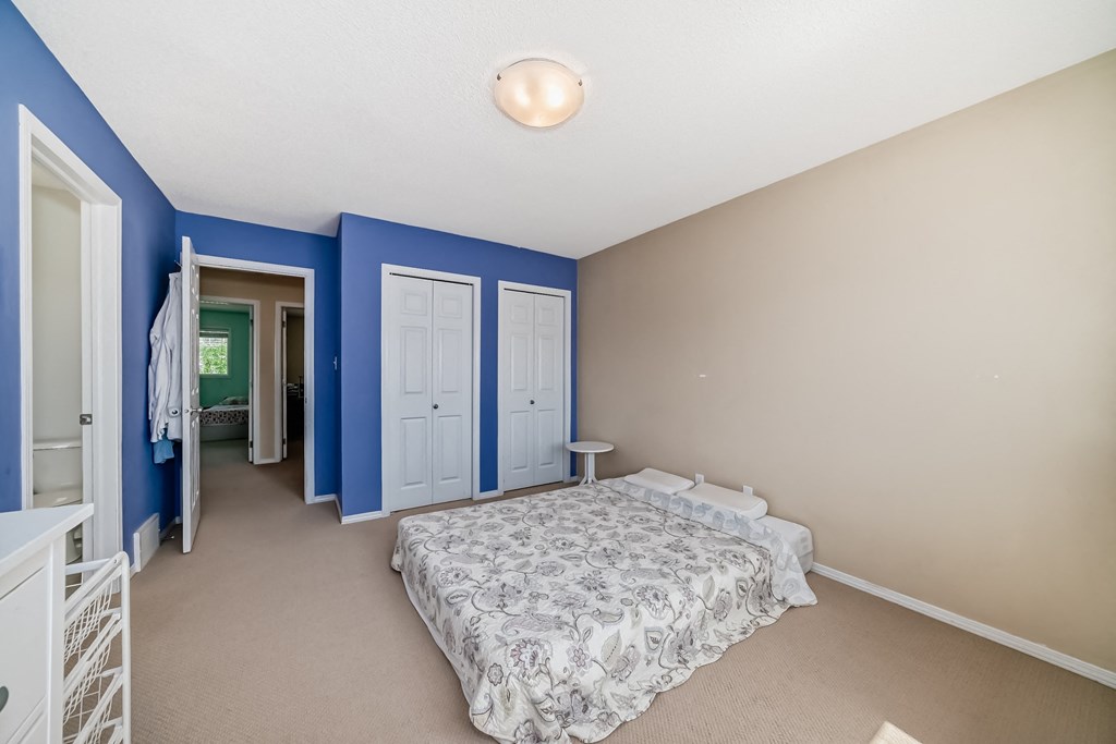 a bedroom with a bed and blue and white walls
