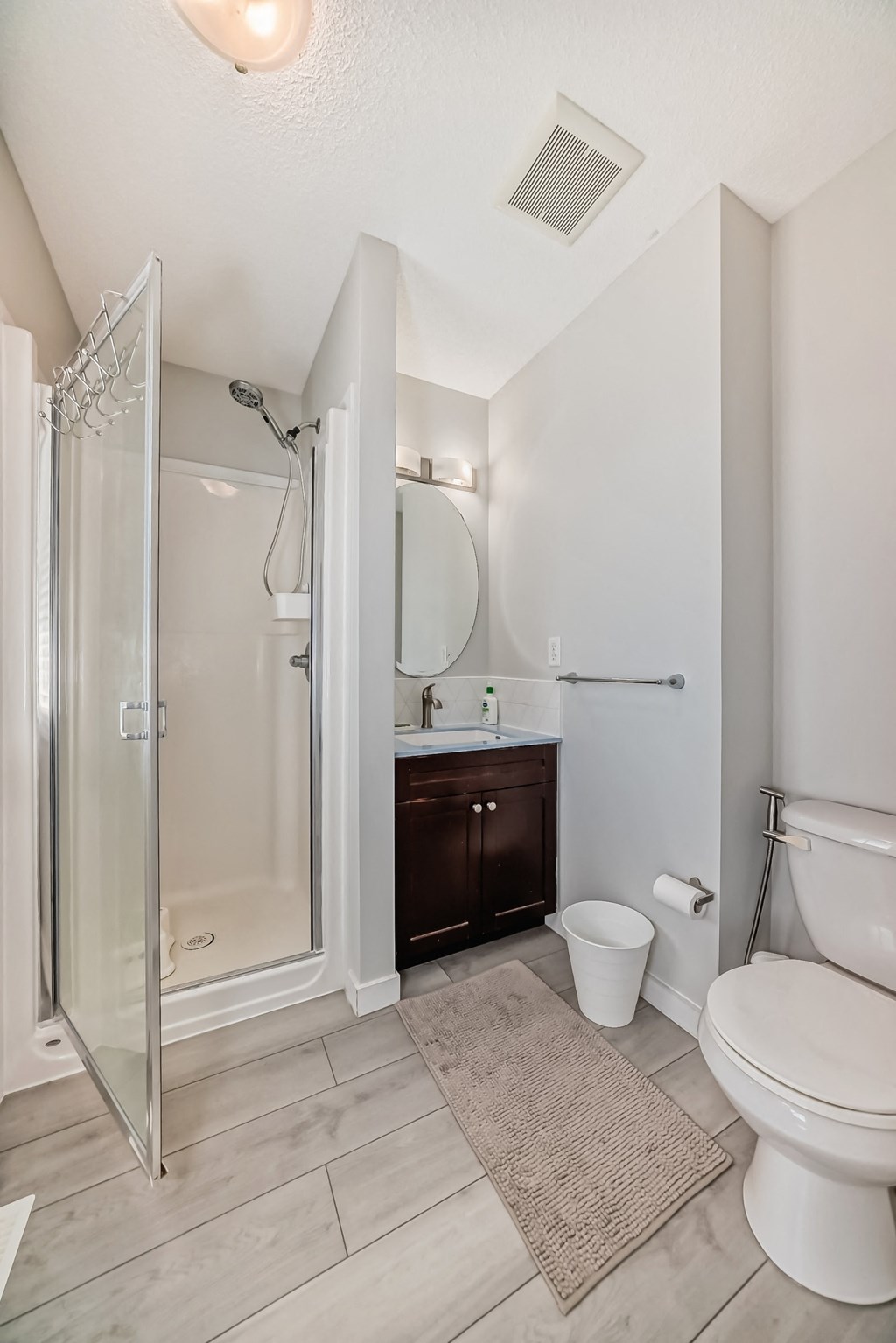 a bathroom with a shower toilet and sink