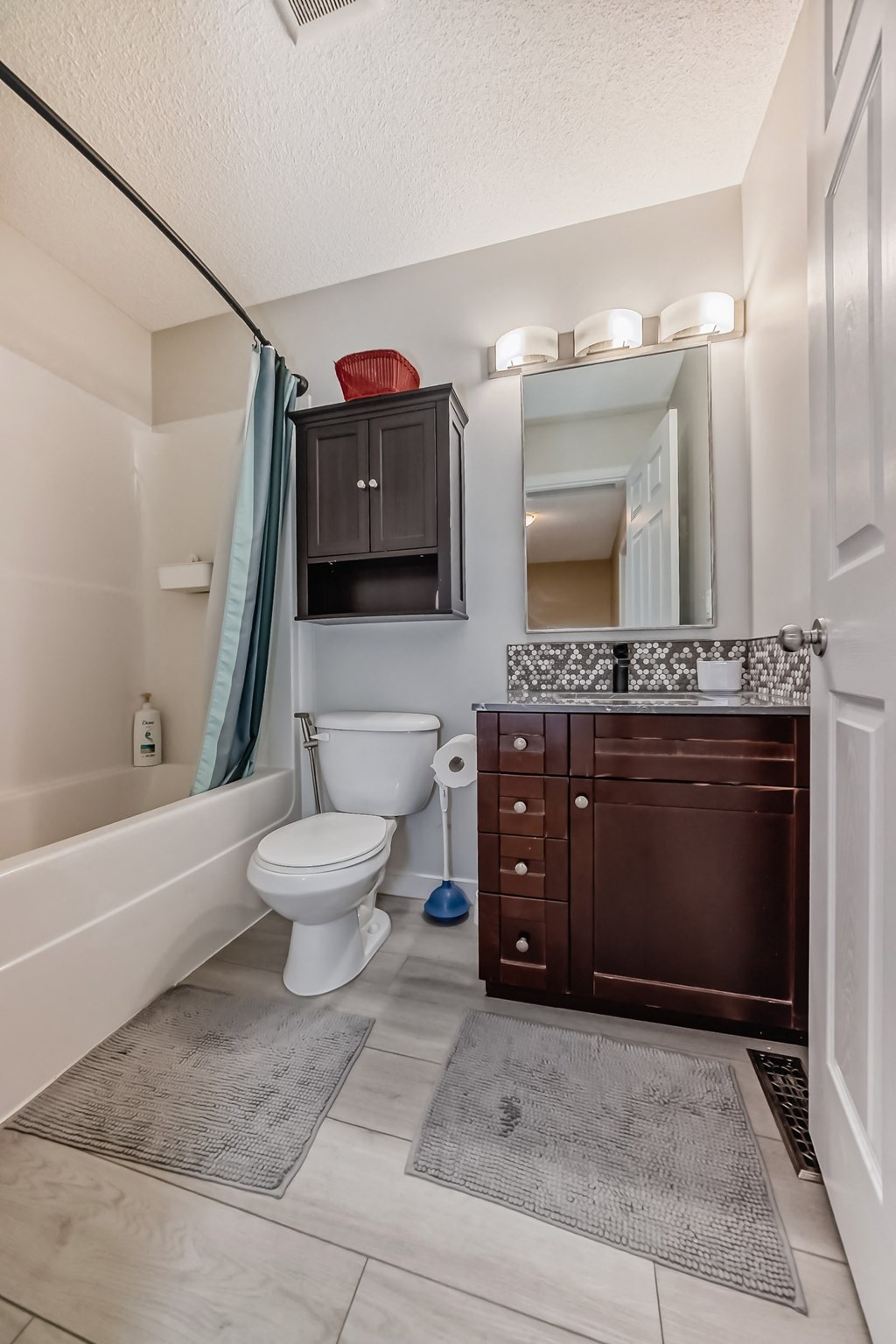 a bathroom with a toilet and a sink and a bath tub