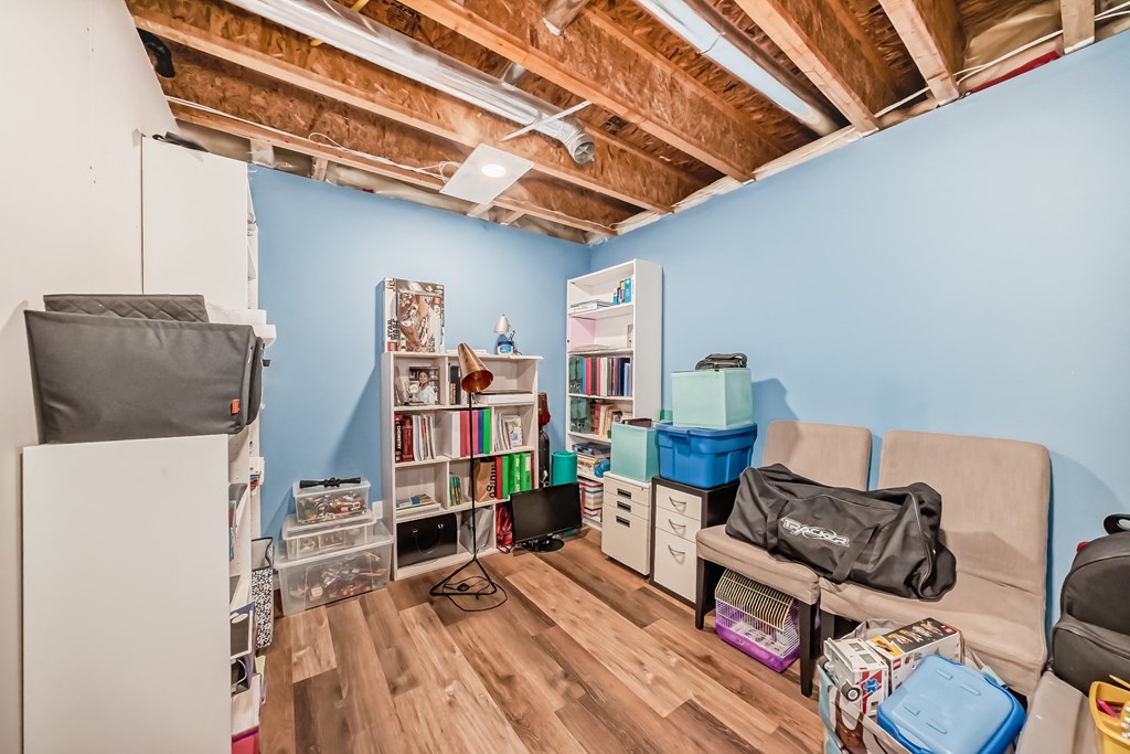a living room filled with furniture and a blue wall