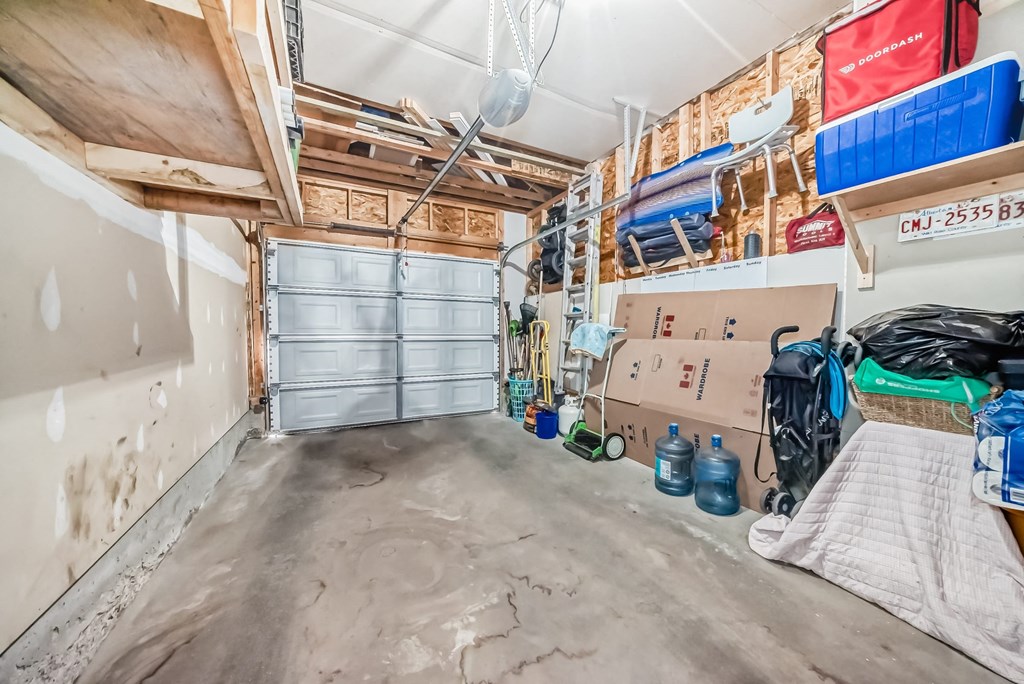 a garage with a door and a bunch of boxes in it