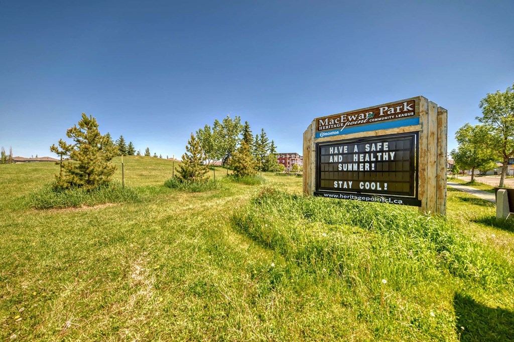 a sign for a park on a grassy field