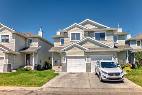 a car parked in the driveway in front of a house