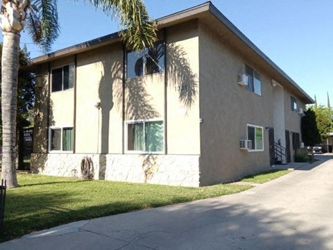 a white house with a palm tree in front of it