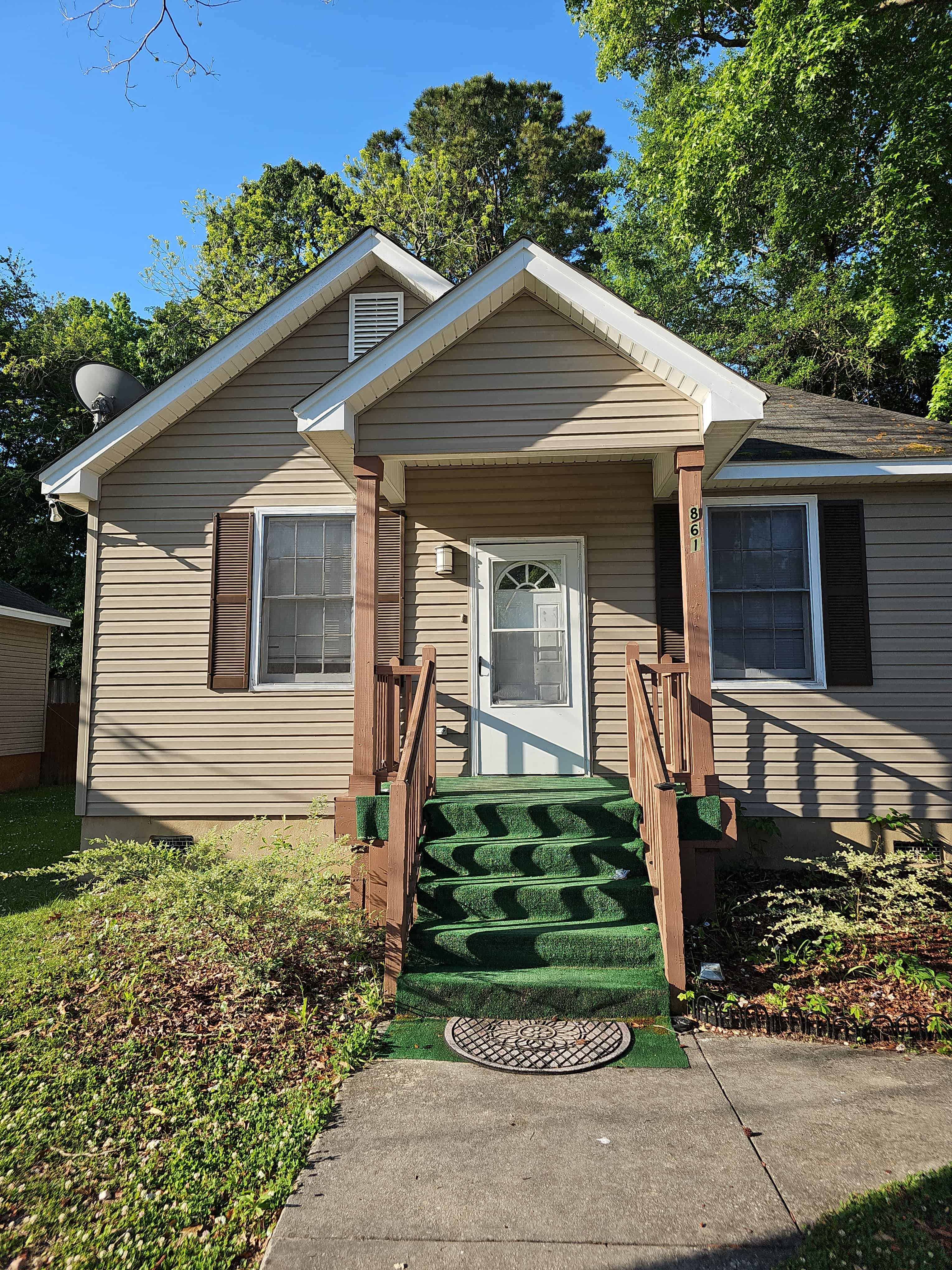 a yellow house with green steps