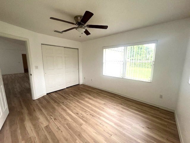 an empty living room with a ceiling fan