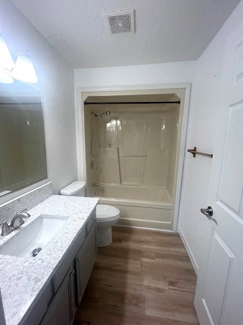 a bathroom with a toilet and a sink and a shower