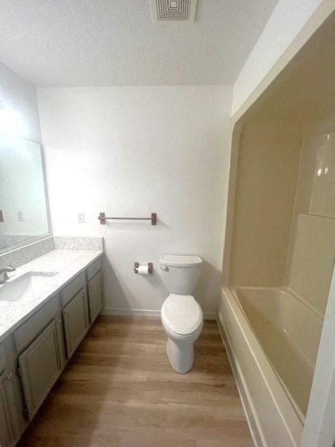a bathroom with a toilet and a sink and a bath tub