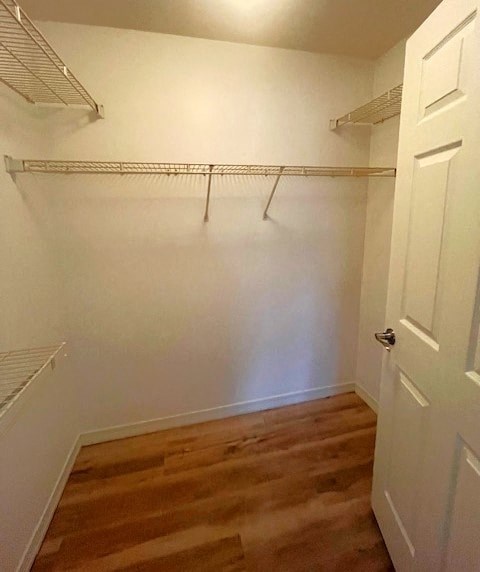 a white closet with white shelves and a door