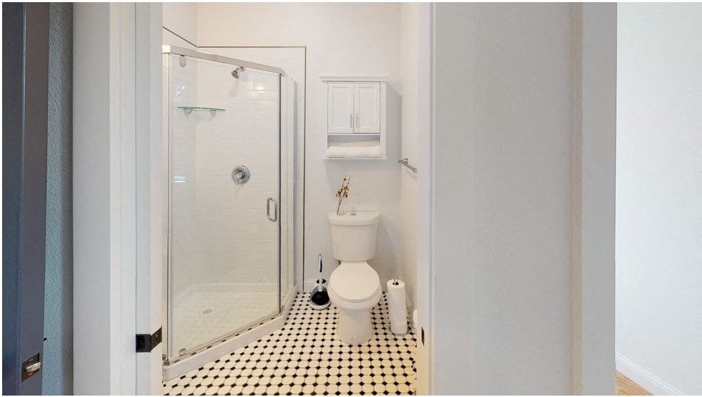 a small bathroom with a toilet and a shower