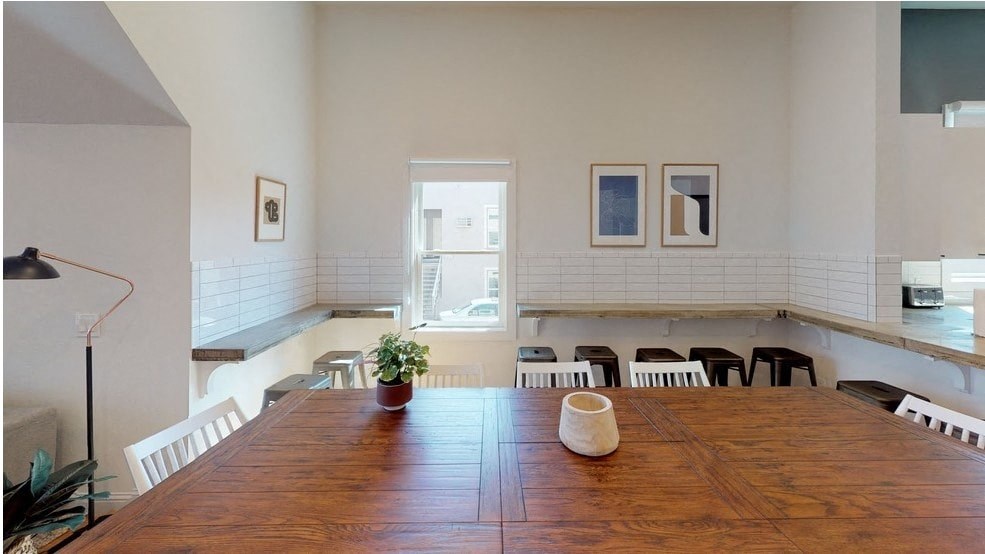 a dining room with a large wooden table and a window