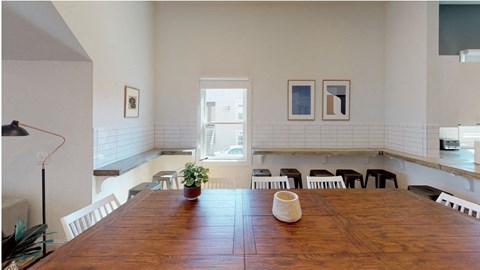 a dining room with a large wooden table and a window