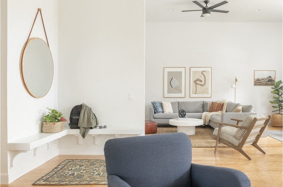 a living room with a couch and a mirror
