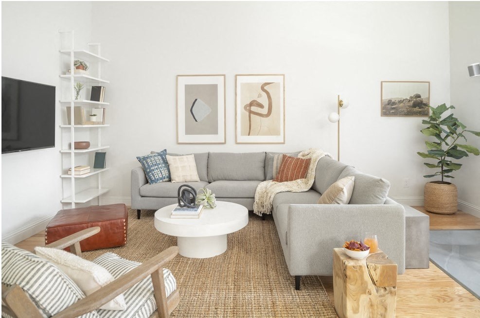 a living room with a gray couch and a white coffee table