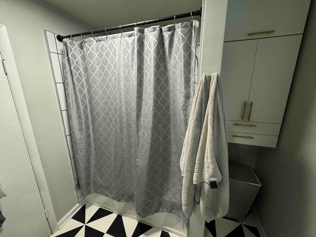 a bathroom with a shower curtain and two towels