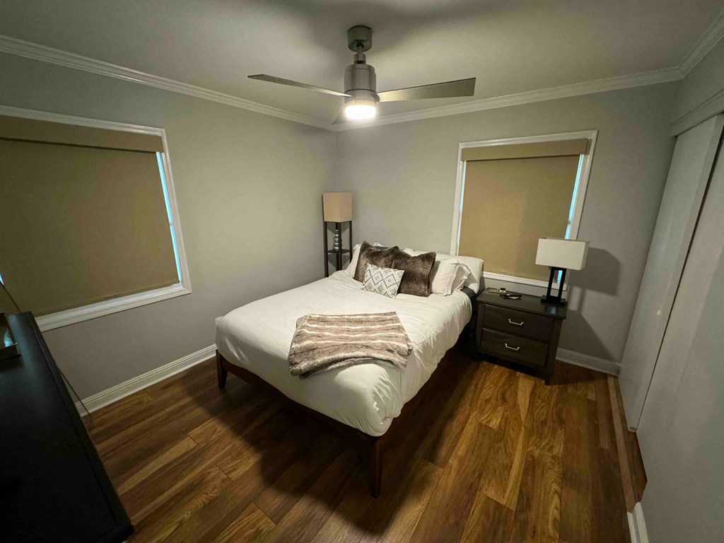 a bedroom with a bed and a ceiling fan