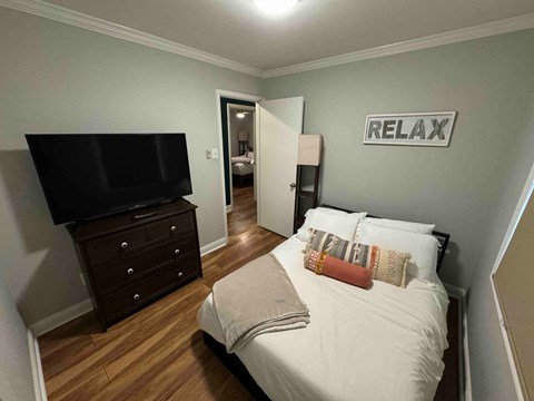 a bedroom with a bed and a tv