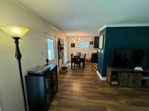 a living room and dining room with a tv and a table